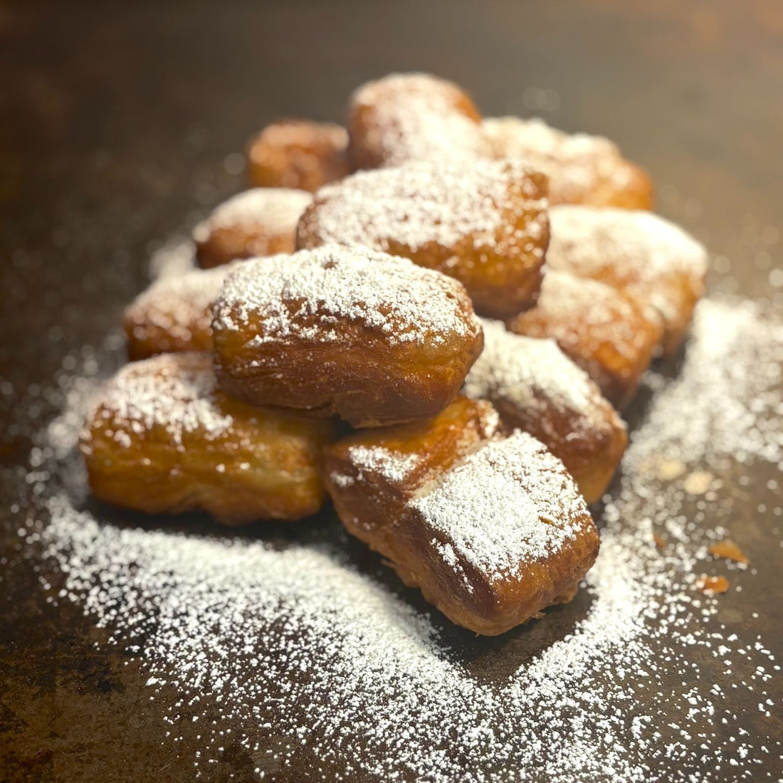 Classic New Orleans Beignets delivered fresh overnight directly from Louisiana! ONly at Boil Baby Boil - One dozen Beignets covered in powdered sugar with available filling chocolate, caramel, or strawberry.