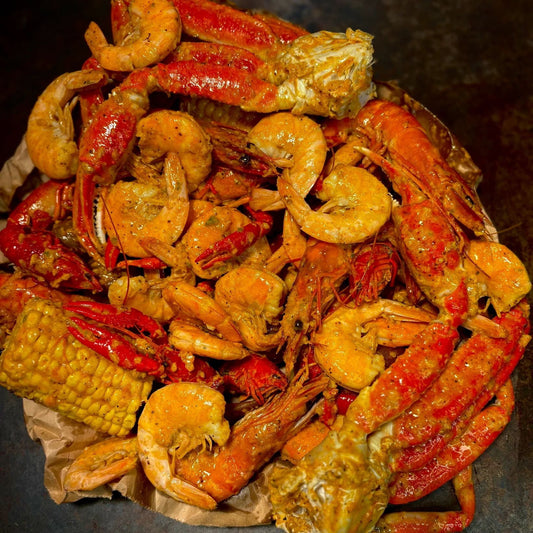 Cajun seafood boil with shrimp, crawfish, crab legs, and corn coated in garlic butter sauce, Boil Baby Boil Los Angeles