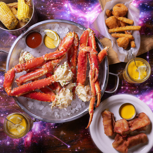 Cajun-style seafood boil platter with snow crab legs, corn, hush puppies, dipping butter, and party sides served Beverly Hills catering special at Boil Baby Boil.