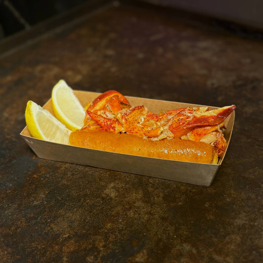 Fresh Connecticut-style lobster roll with buttered brioche bun and lemon wedges, served at Boil Baby Boil in West Hollywood as part of the late night seafood menu.