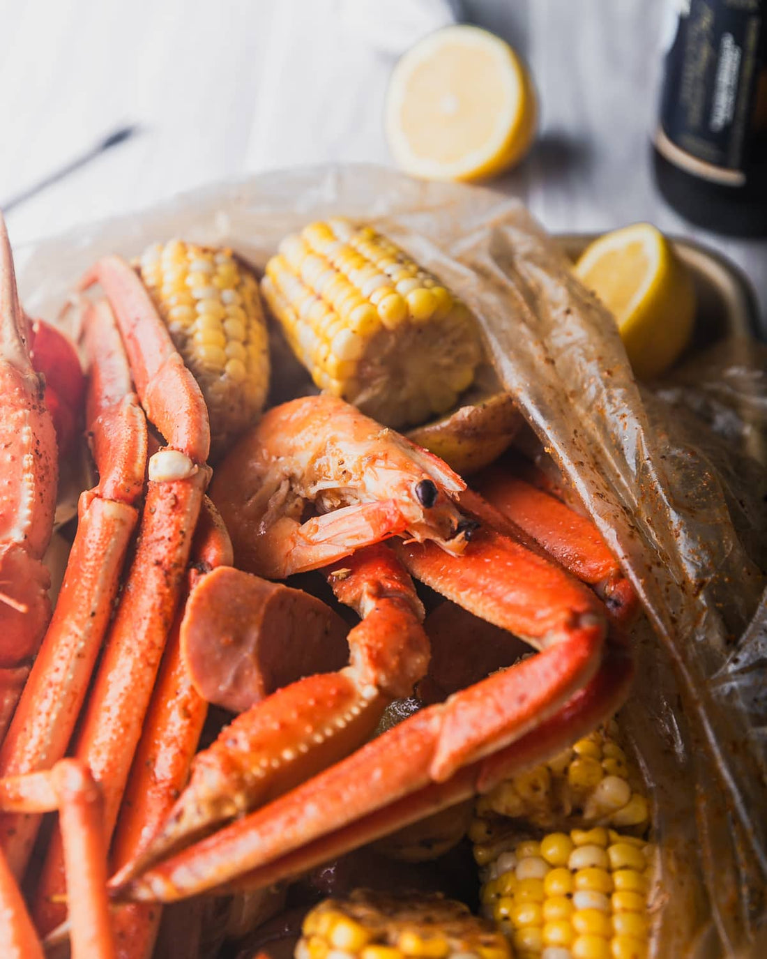 Snow crab clusters, peel-and-eat shrimp, and Cajun sweet corn from a Boil Baby Boil seafood boil bag — bold takeaway flavor at home
