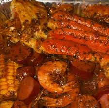 Cajun seafood boil spread with shrimp, crawfish, andouille sausage, and corn — late night delivery from Boil Baby Boil in West Hollywood