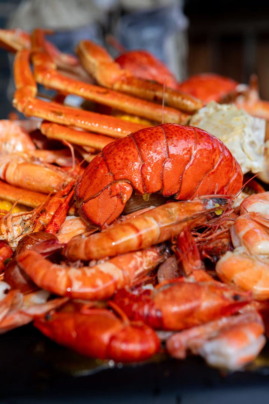 fresh lobster tail and shrimp seafood spread highlighting ingredients used in authentic new england and connecticut style lobster rolls