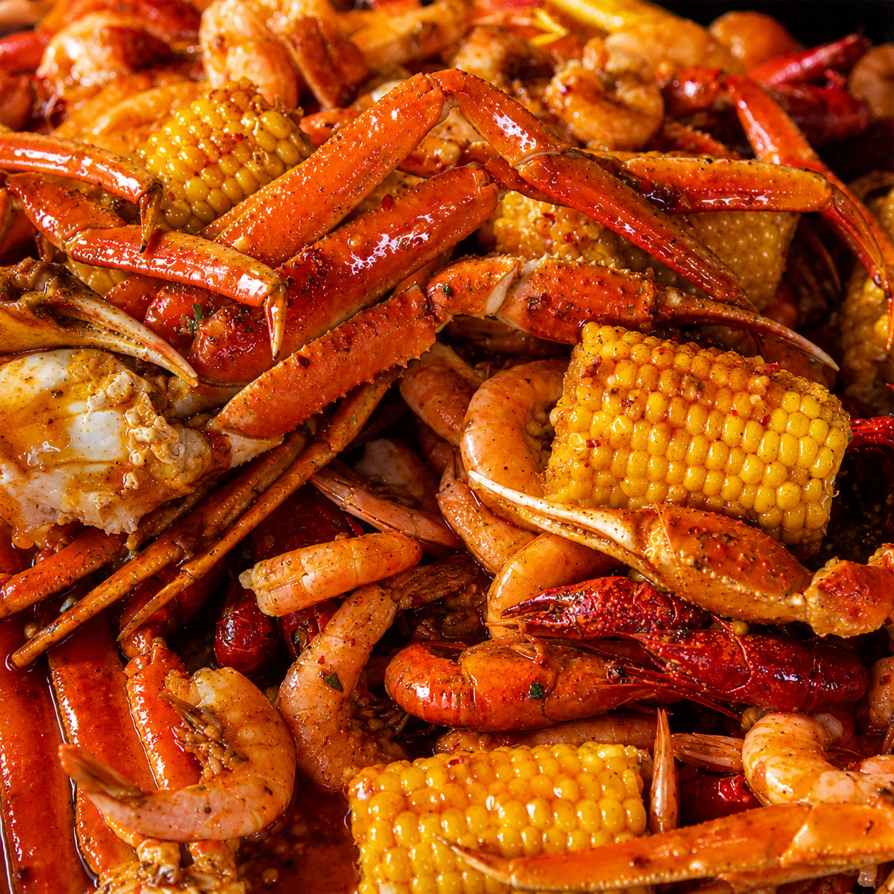 catering for a pool party best prices in West Hollywood advertisement by showing a few clear plastic bags of saucy and spice filled seasoned crab legs!