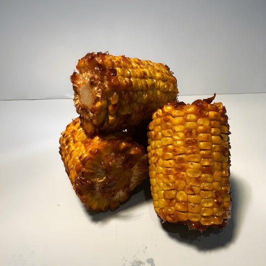 Three buttery Cajun corn-on-the-cob pieces glistening with spice—Boil Baby Boil’s signature side dish in West Hollywood, perfect for late-night seafood boil orders and comfort food cravings.
