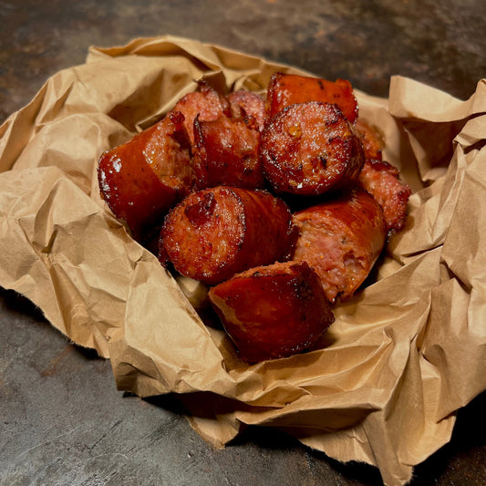 House-smoked andouille sausage served in butcher paper bowl at Cajun seafood boil restaurant in Los Angeles