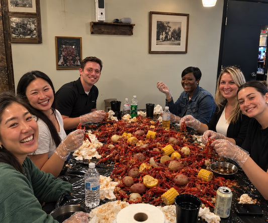 Los Angeles seafood catering spread with seasoned shellfish, corn, and potatoes for group events.