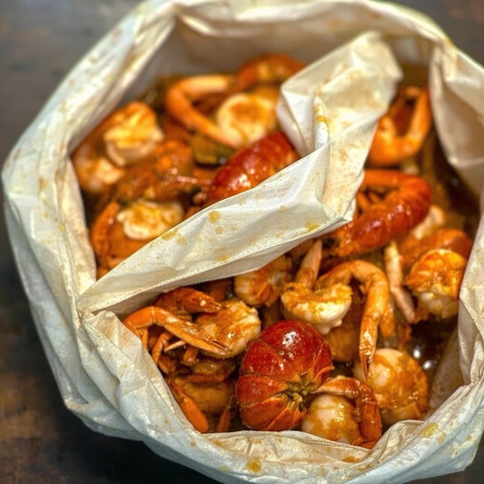 Close-up of a spicy Cajun seafood boil bag with lobster tails, shrimp, and garlic butter sauce—Boil Baby Boil’s fan-favorite DoorDash delivery hit in West Hollywood, perfect for messy midnight cravings.