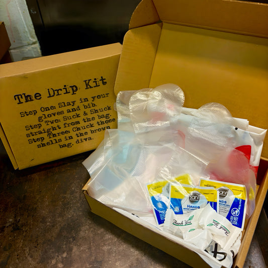 Yellow Drip Kit box for Cajun seafood boil in Los Angeles with bibs, gloves, wipes, and after-dinner mints